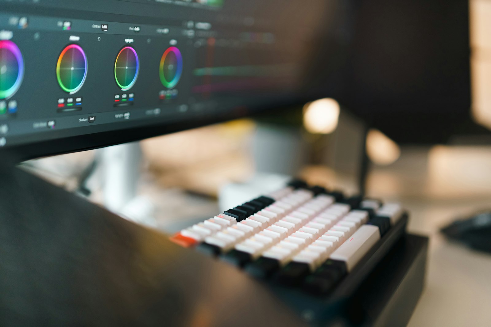 Close-up of a computer monitor and keyboard on a creative workspace desk.