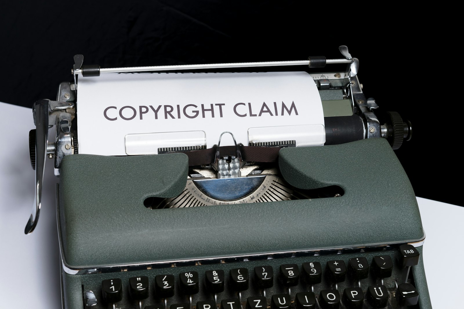 A typewriter with a sheet of paper reading 'Copyright Claim' rolled into it.